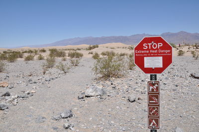 Information sign on road against sky