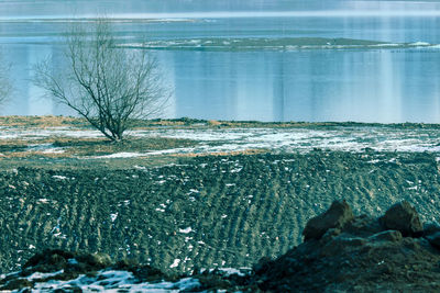 Close-up of frozen sea against sky during winter