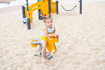 Full length of boy playing on sand at beach