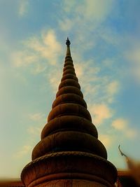 Low angle view of temple against cloudy sky