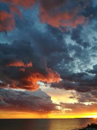 Scenic view of dramatic sky over sea during sunset