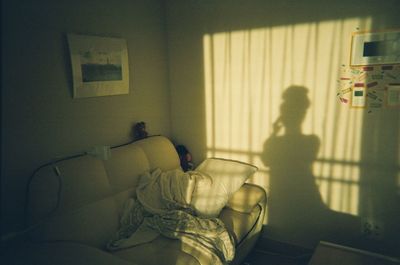 Shadow of woman on wall at home