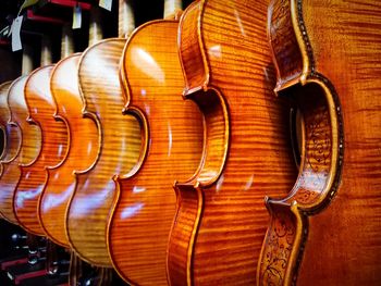 Violins arranged in row for sale