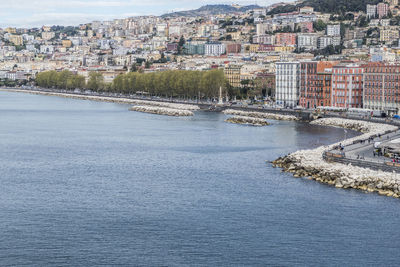 Aerial view of river amidst buildings in city