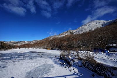 Snow covered mountain against blue sky