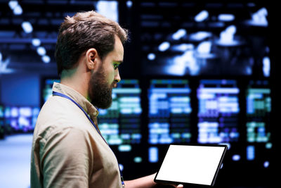 Side view of businessman using digital tablet in office