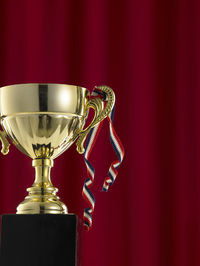 Close-up of trophy against red curtain