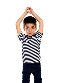 Portrait of boy standing against white background