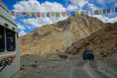 Road amidst mountains against sky