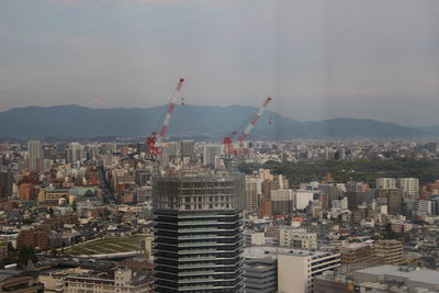 Aerial view of modern buildings in city against sky