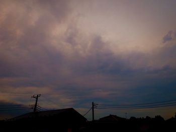 Low angle view of silhouette houses against sky during sunset