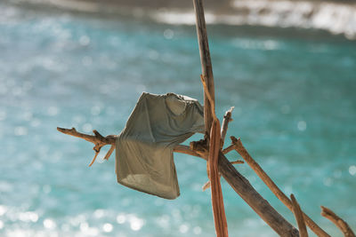Clothes drying on rope against sea