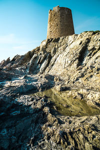 Low angle view of rock formations against sky