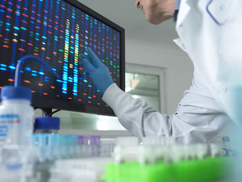 Scientist analyzing dna on computer screen at laboratory