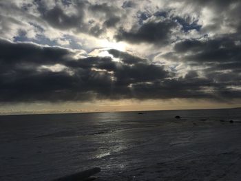 Scenic view of sea against storm clouds