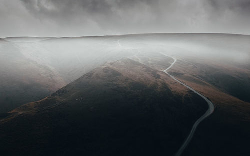 Aerial view of misty mountains and sky