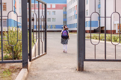 Back to school. girl in school uniform go to school with backpack behind their backs. beginning 