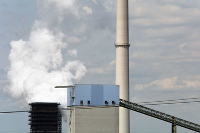 Low angle view of factory against sky