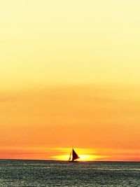 Scenic view of sea against orange sky