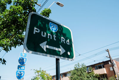 Low angle view of road sign against clear sky