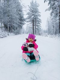 View of girl in snow covered field