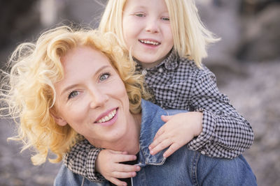 Portrait of happy woman and son with blond hair