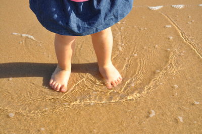 Low section of boy on beach