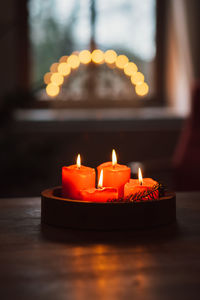 Close-up of illuminated candles on table