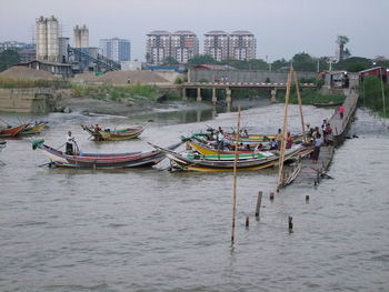 View of boats in city at waterfront