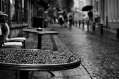 Wet table at sidewalk cafe during rainy season