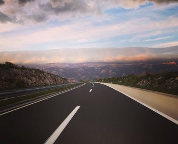 Empty road leading towards mountains