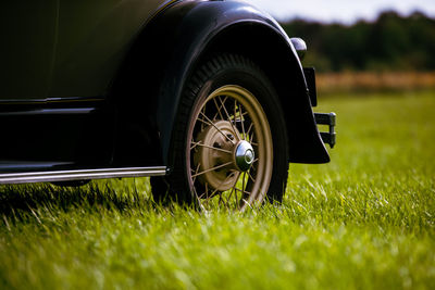 Close-up of vintage car on field