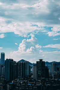 Buildings in city against sky