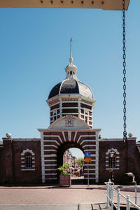 Facade of building against clear blue sky