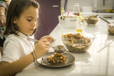 Girl having food on table