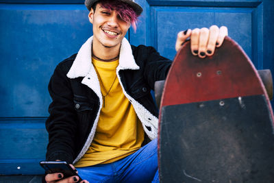 Portrait of young man sitting outdoors