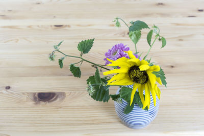 Close-up of yellow flower vase on table