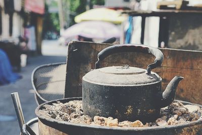 Close-up of traditional kettle on traditional charcoal stove