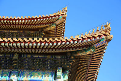 Low angle view of temple against clear blue sky