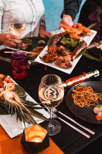 Midsection of woman holding food on table