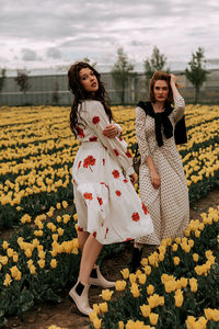 Flowers in a field with beautiful girls. huge selection of tulips and rapeseed