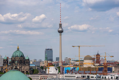 Television tower in city against sky