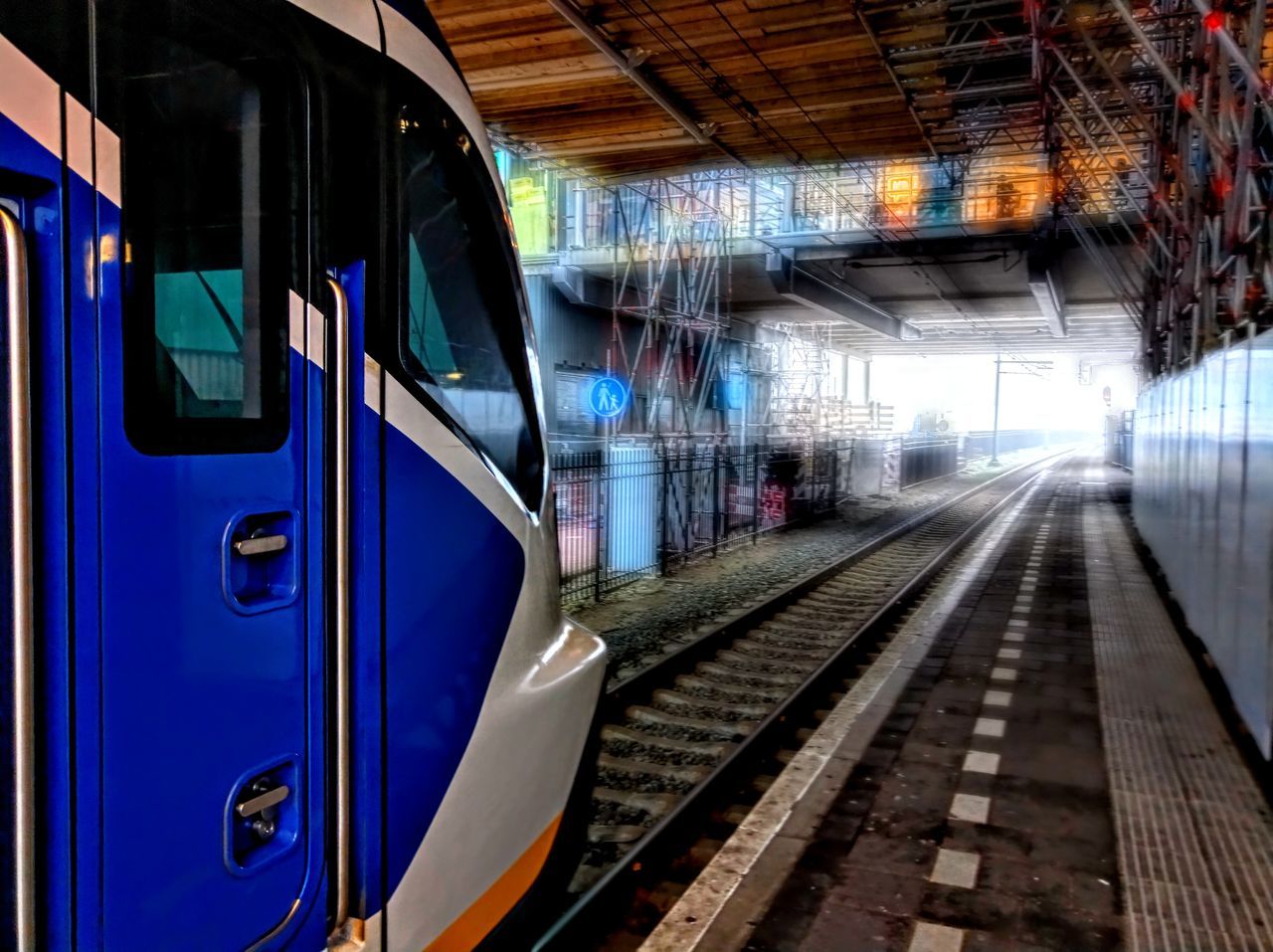 TRAIN IN RAILROAD STATION PLATFORM