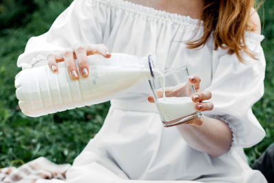 Midsection of woman holding wineglass