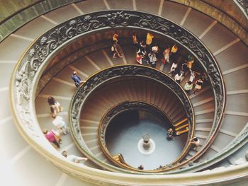 High angle view of people walking on bramante staircase in vatican museums