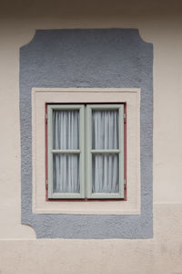 Low angle view of window on wall of building