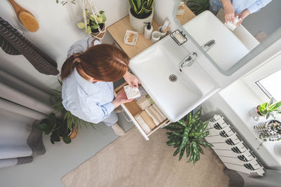 High angle view of woman sitting on table