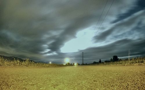 View of fields against cloudy sky