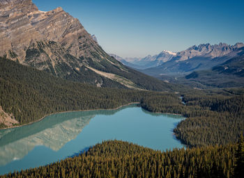 Scenic view of lake and mountains against blue sky