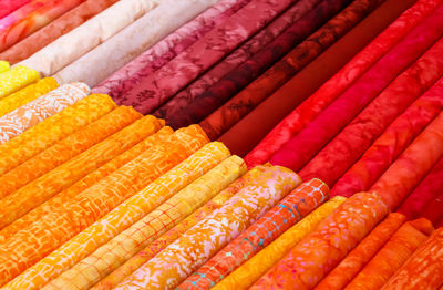 Detailed close up view on samples of cloth and fabrics in different colors found at a fabrics market